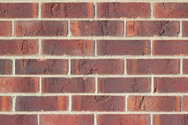 istock Textured rusty brown color traditional brick wall background 1008237808