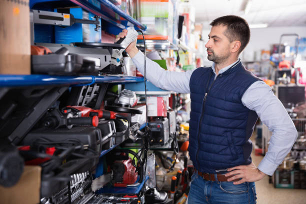istock Adult male is looking on new grinder in tools store. 1008237900