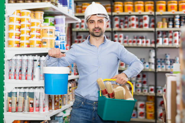 istock guy in helmet with paint and instruments for repair 1008238378