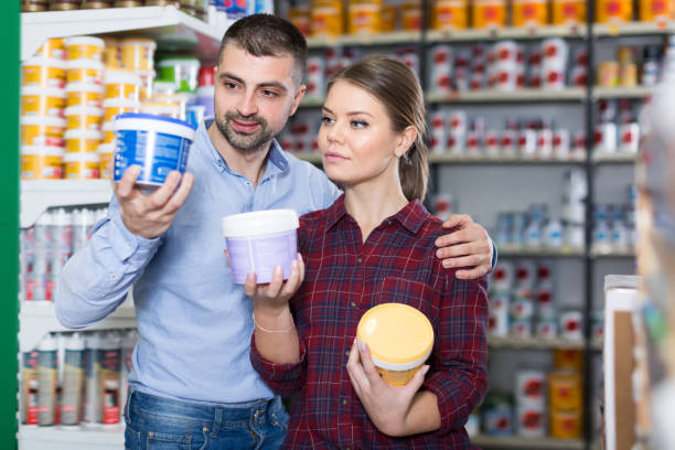 istock Two glad designers are choosing paint for room 1008238402