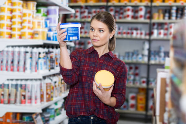 istock Woman is choosing with paint for repair 1008238430
