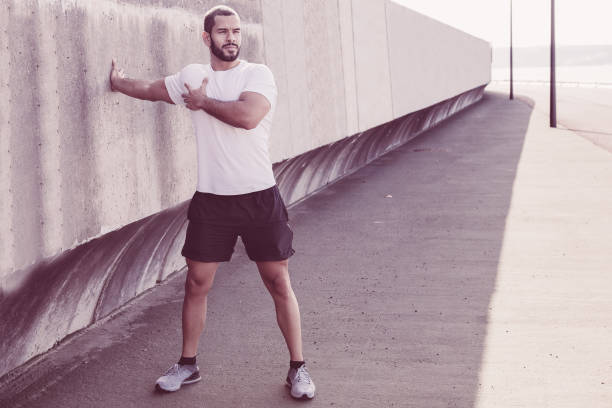 istock Strong Sporty Man Stretching Arm Outdoors 1008241334