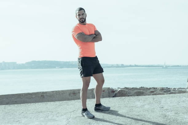 istock Serious Strong Athlete Standing Outdoors in Summer 1008241362