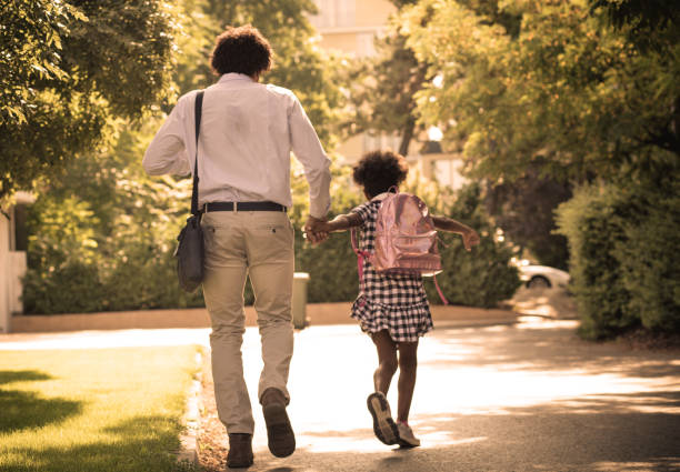 istock Father and daughter running trough park. 1008241436