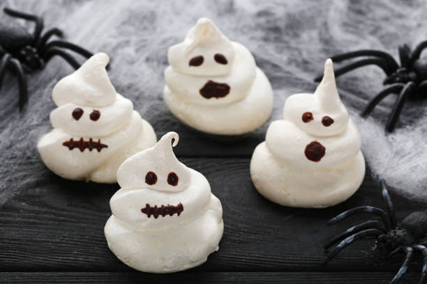 istock Halloween meringue with spiders on black wooden table 1008246930