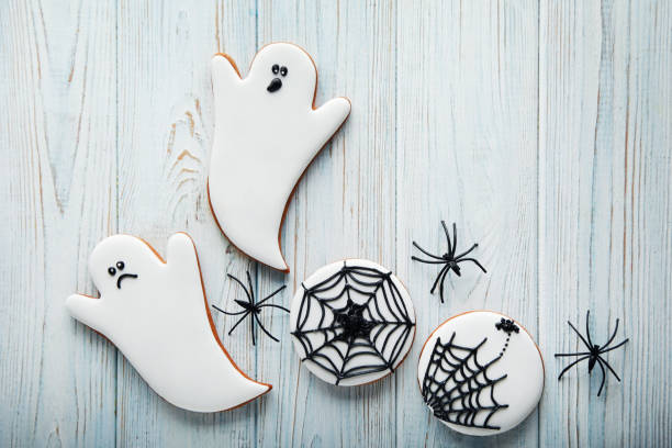 istock Halloween gingerbread cookies on white wooden table 1008248986