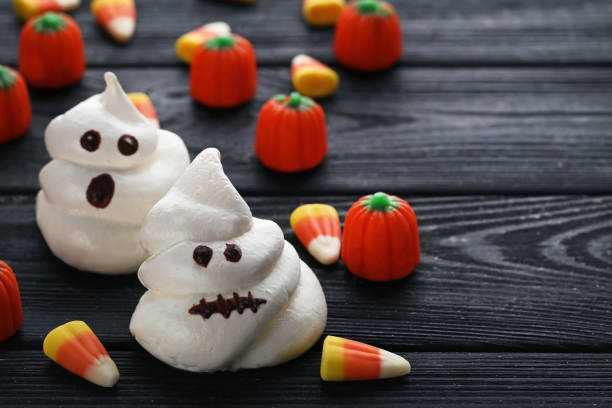 istock Halloween meringue with candies on black wooden table 1008254048