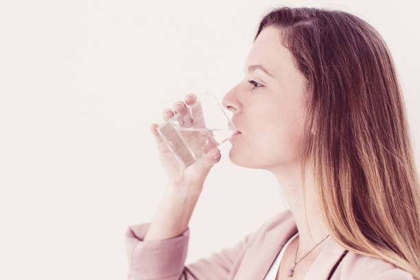 istock Confident young businesswoman drinking water 1008254082