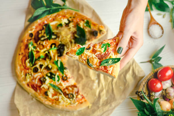istock Hands taking slices of pizza. Hand holding slice pizza. 1008257118