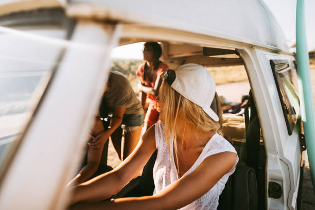 istock Smiling woman driving mini van during the road trip 1008257262