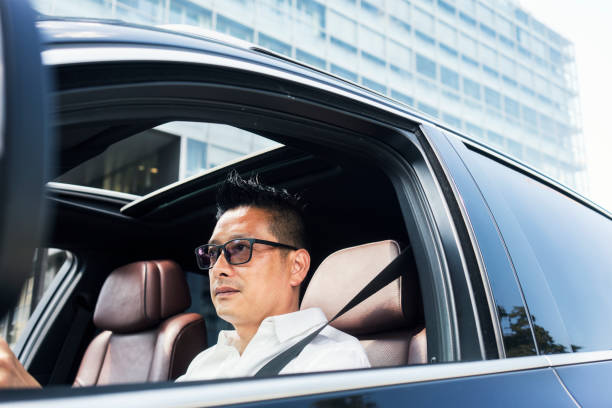 istock Chinese businessman draving a car 1008257356
