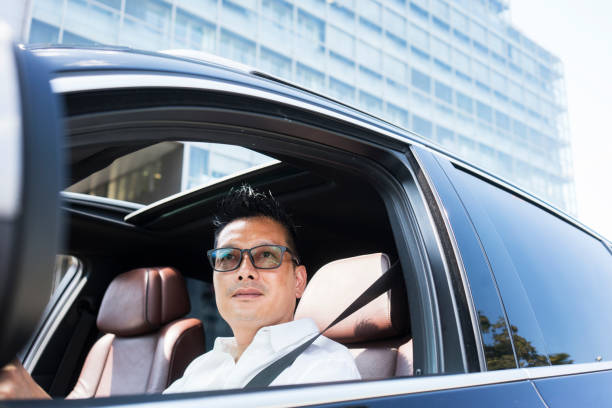 istock Chinese businessman draving a car 1008257490
