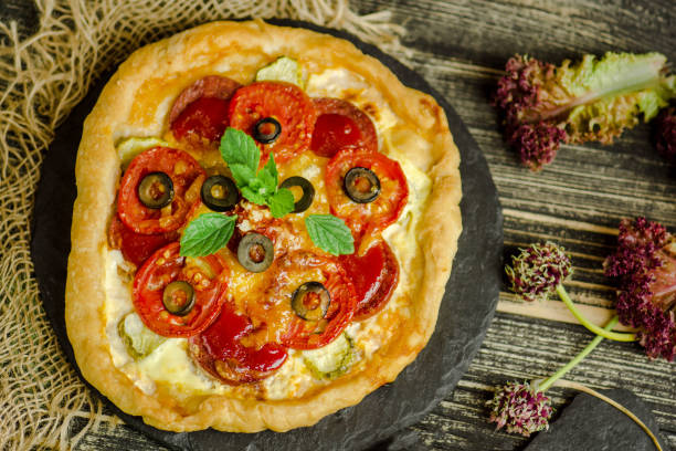 istock Hot pizza with cheese on a rustic wooden board 1008258376