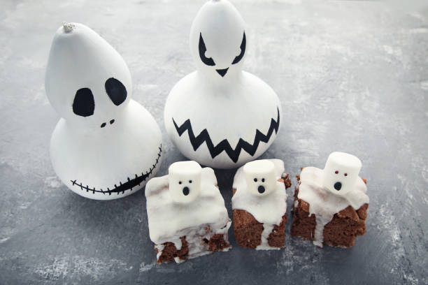 istock Halloween cookies with marshmallows and pumpkins on grey wooden table 1008261442