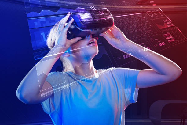 istock Emotional girl feeling impressed while wearing virtual reality device 1008262898