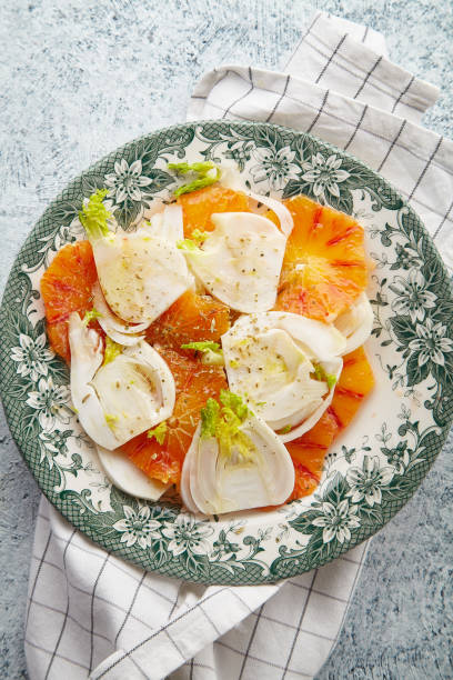 istock Fresh salad with red orange and fennel on textured background 1008263758