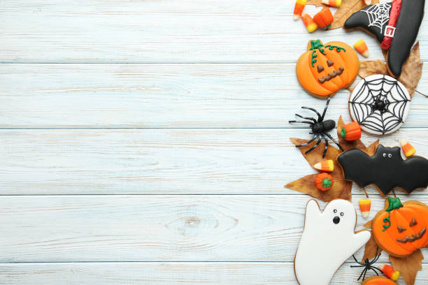 istock Halloween gingerbread cookies with candies on white wooden table 1008268238