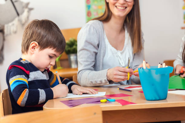 istock Teacher supports baby boy at kindergarten 1008268410