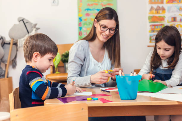 istock Preschool Teacher with Children at Kindergarten - Creative Art Class 1008268554