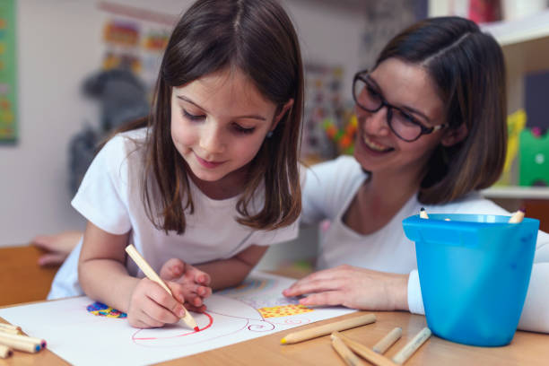 istock Mother with her child having creative and fun time drawing 1008268638