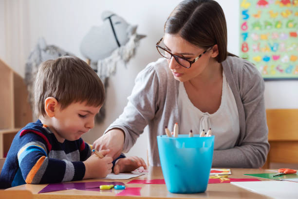 istock Teacher supports baby boy at kindergarten 1008268684