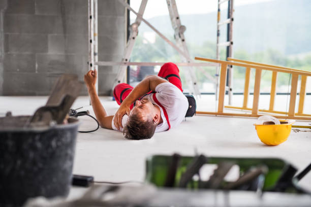 An accident of a man worker at the construction site. Accident of a male worker at the construction site. An injured man on the floor. crash stock pictures, royalty-free photos & images