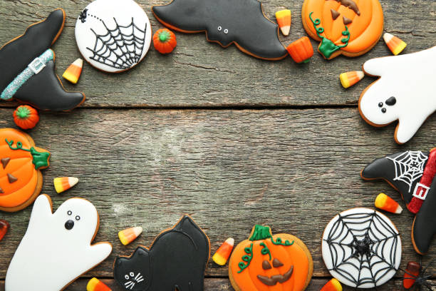 istock Halloween gingerbread cookies with candies on wooden table 1008268794