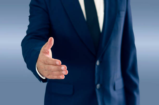 istock A businessman is standing and shaking hands. copy space for your text. 1008268832