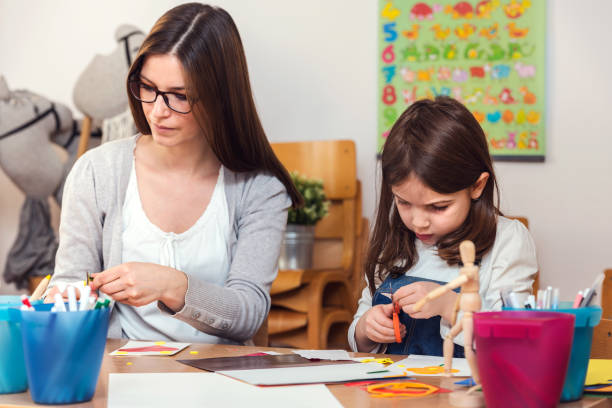 istock Preschool Teacher With Cute Girl - Creative Art Class 1008268878