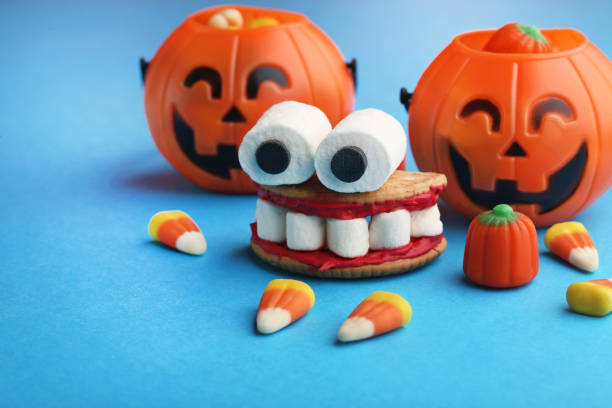 istock Halloween cookies mouth with marshmallows on blue background 1008274312