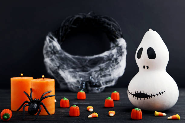 istock Halloween candy corns with pumpkin and spider on wooden table 1008274706