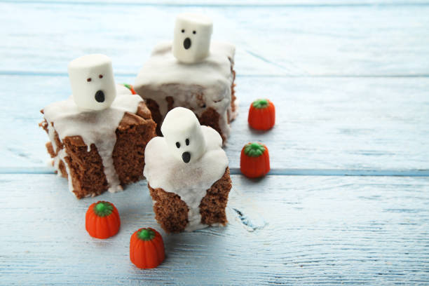 istock Halloween cookies with marshmallows and pumpkins on wooden table 1008275042