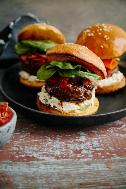 istock Burgers with grilled beef patties, cream cheese and spinach on classical bun. 1008275254
