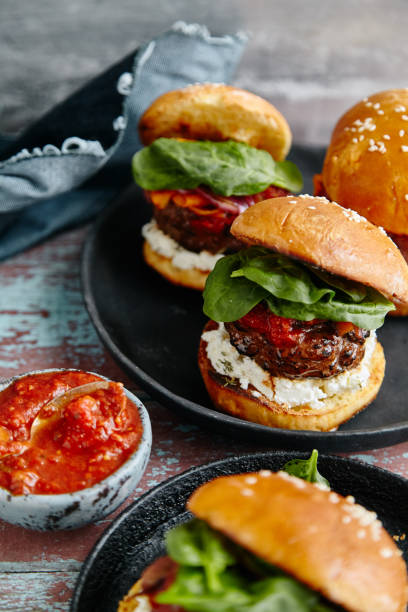 istock Burgers with grilled beef patties, cream cheese and spinach on classical bun. 1008275302