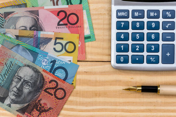 istock Australian dollars, pen and calculator on wooden background 1008277464