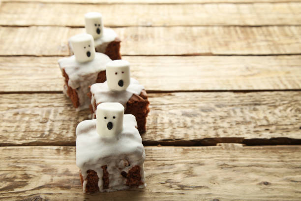 istock Halloween cookies with marshmallows on brown wooden table 1008277894