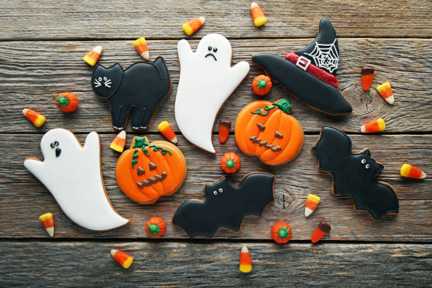 istock Halloween gingerbread cookies with candies on grey wooden table 1008278010