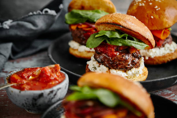 istock Burgers with grilled beef patties, cream cheese and spinach on classical bun. 1008278026
