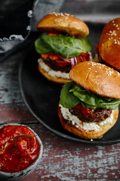 istock Burgers with grilled beef patties, cream cheese and spinach on classical bun. 1008278030