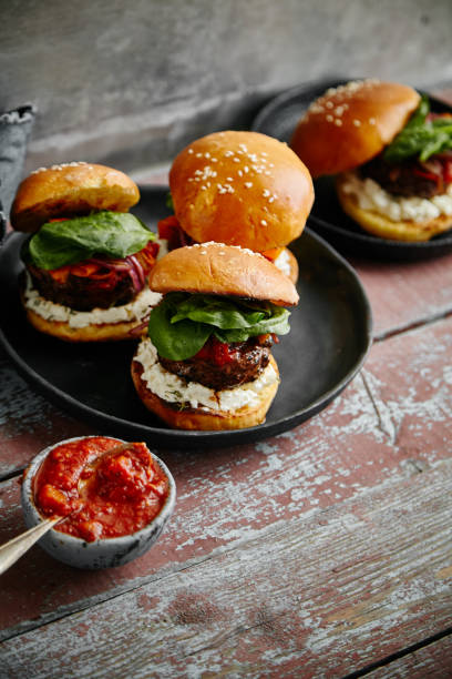 istock Burgers with grilled beef patties, cream cheese and spinach on classical bun. 1008278068