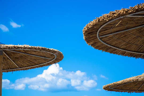 istock Wooden beach umbrella under the blue sky 1008278196