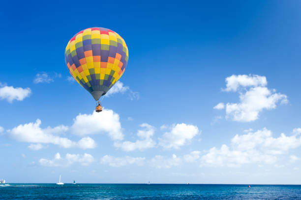 istock Colorful Hot air balloon over blue sea 1008278366