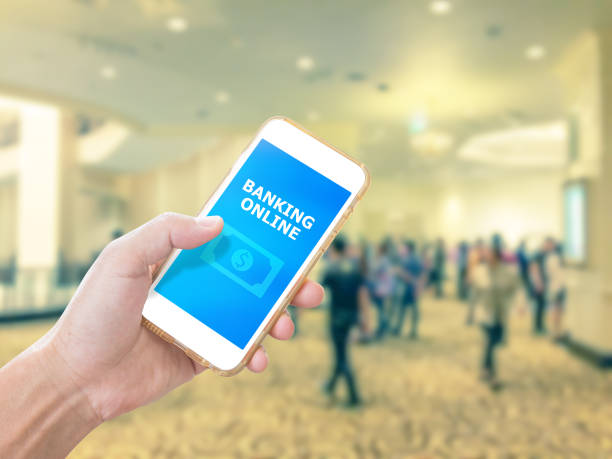 istock Hand holding smartphone with mobile banking application on screen 1008278398