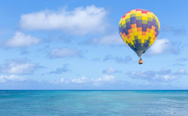 istock Hot air balloon over blue sea 1008278510