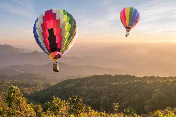 istock Hot air balloon over mountain at sunset 1008278538
