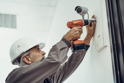 Electrician installing security system