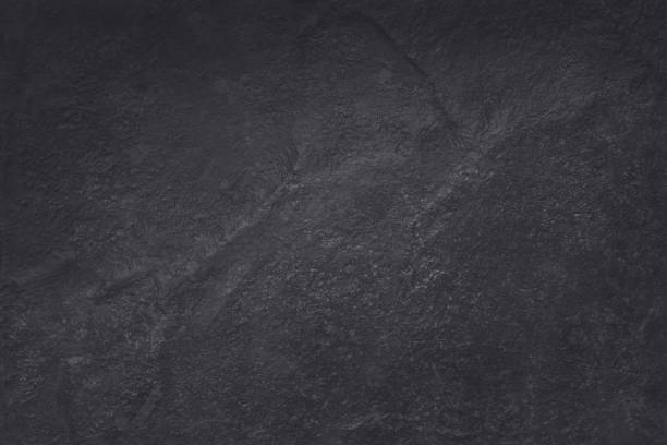 istock Dark grey black slate texture in natural pattern with high resolution for background and design art work. Black stone wall. 1008281560