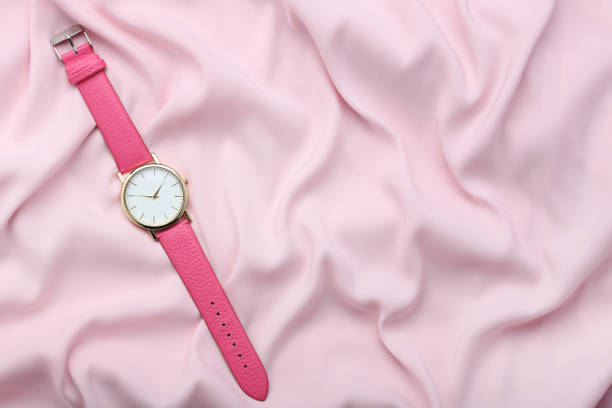 istock Wrist watch on pink satin background 1008284584