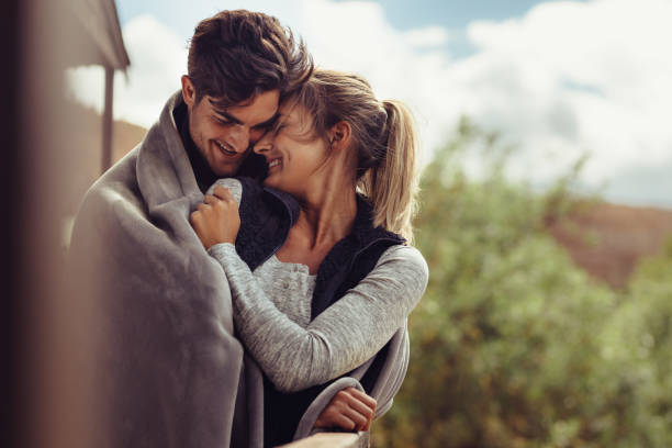 istock Romantic couple wrapped in blanket outside 1008284766