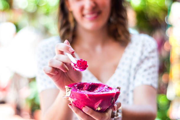 istock beautiful unfocused background eating fruit, specifically dragon fruit in a fruit market. 1008284842